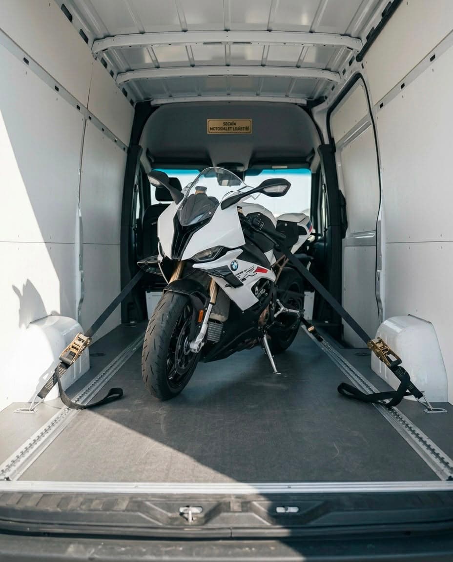 Beyaz BMW motosiklet kapalı kasa panelvan içinde güvenli şekilde sabitlenmiş